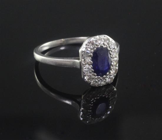 A 1920s/1930s platinum?, sapphire and diamond oval cluster ring, size M.